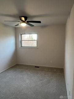 carpeted empty room featuring ceiling fan