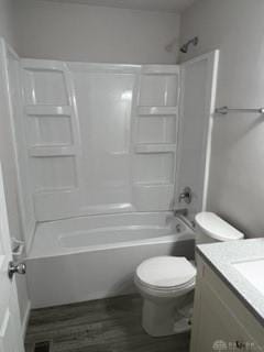 full bathroom featuring shower / bathing tub combination, hardwood / wood-style floors, vanity, and toilet