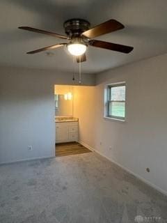 carpeted spare room with ceiling fan