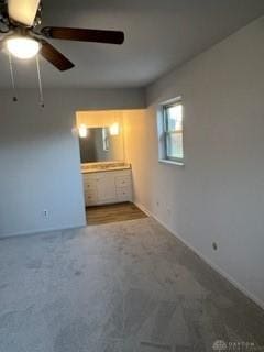 interior space with ceiling fan and carpet floors