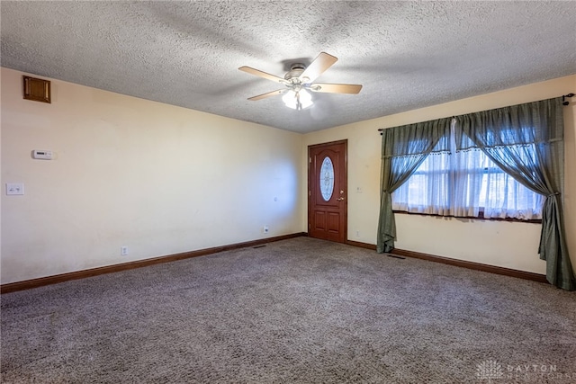 carpeted entrance foyer featuring a textured ceiling and ceiling fan