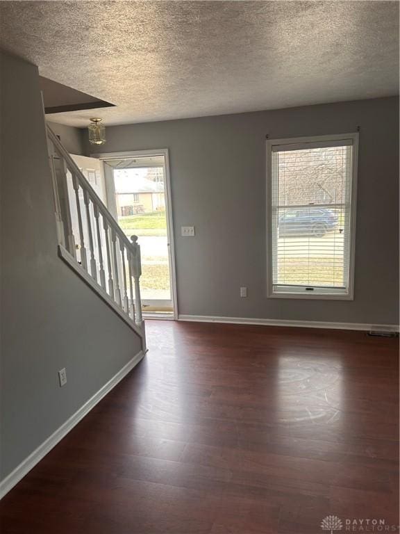 entryway featuring dark hardwood / wood-style floors and a textured ceiling