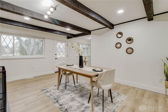 home office with beam ceiling and light hardwood / wood-style flooring