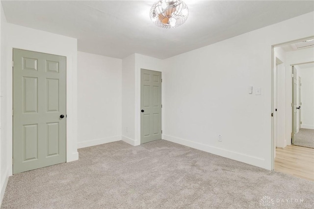 unfurnished bedroom featuring light carpet