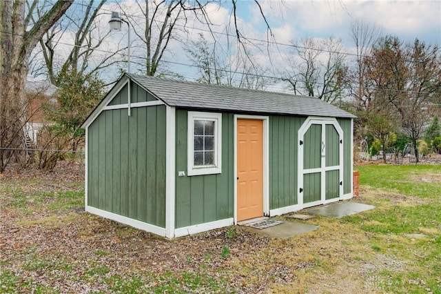 view of outdoor structure featuring a lawn