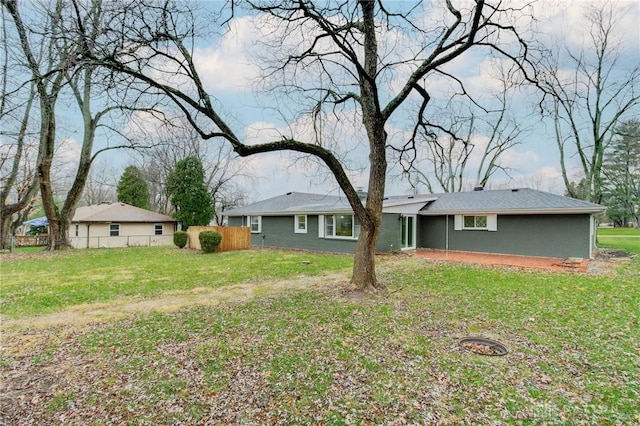 back of house featuring a lawn