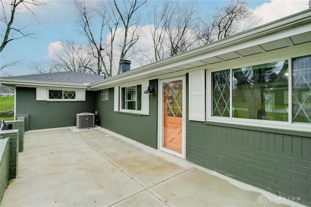 exterior space with cooling unit and a patio area