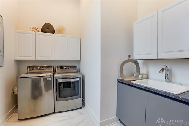 laundry room with cabinets, independent washer and dryer, and sink