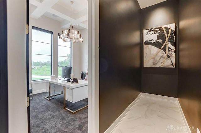 office space featuring dark colored carpet, an inviting chandelier, beam ceiling, and coffered ceiling