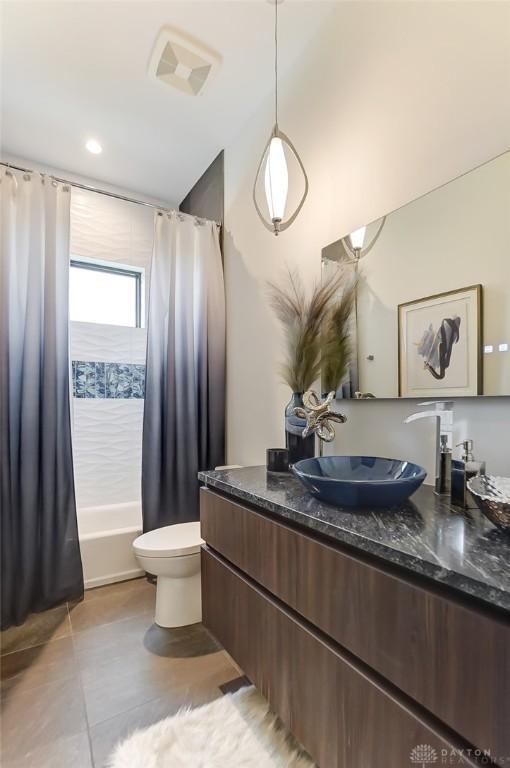 full bathroom featuring tile patterned floors, shower / bath combo, toilet, and vanity