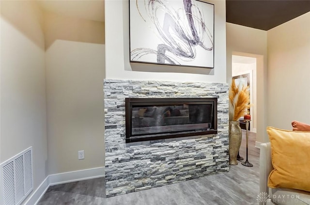 details with a fireplace and wood-type flooring