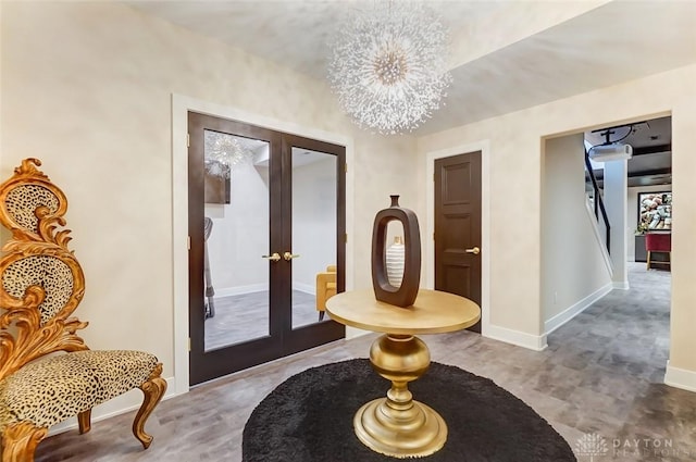 foyer entrance featuring french doors and a notable chandelier