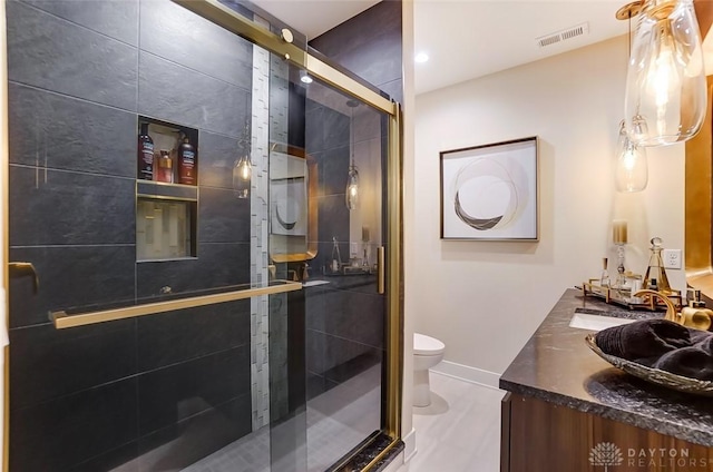 bathroom with vanity, toilet, and walk in shower