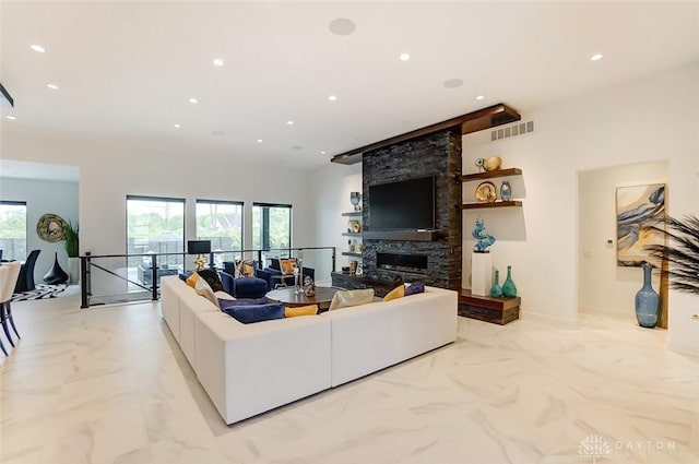 living room with a stone fireplace