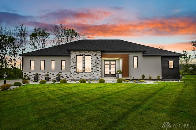 view of front of property featuring a lawn and french doors