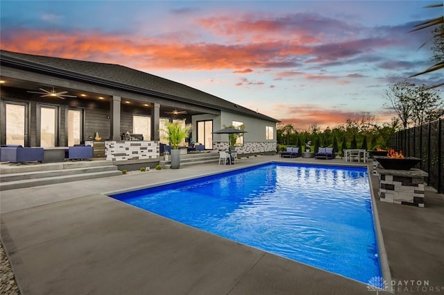 pool at dusk with a patio