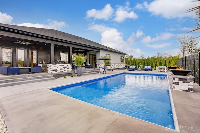 view of swimming pool with ceiling fan and a patio