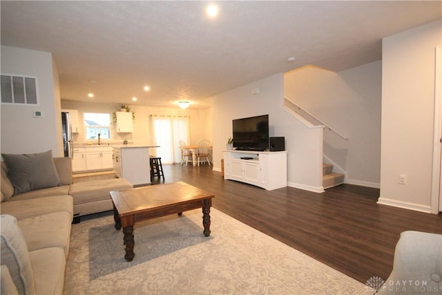 living room featuring dark hardwood / wood-style floors and sink