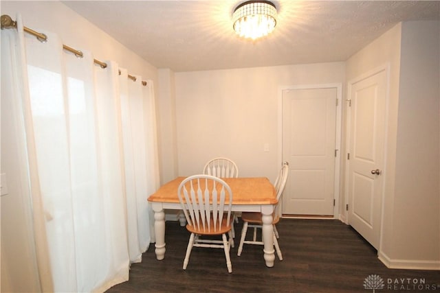 dining area with dark hardwood / wood-style floors