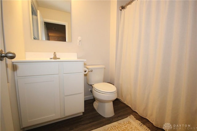 bathroom with hardwood / wood-style flooring, vanity, and toilet