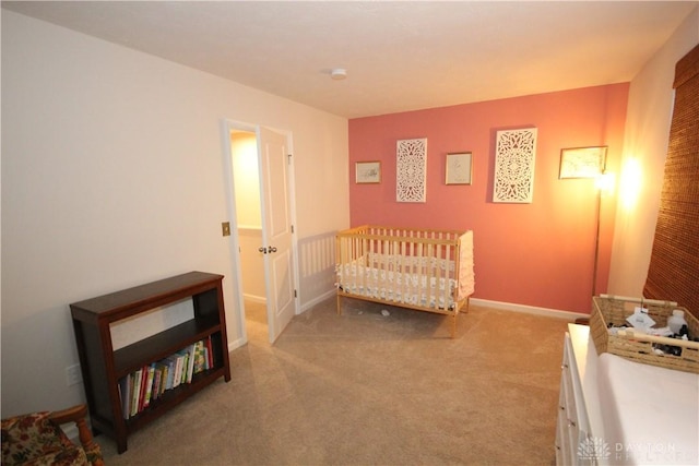 bedroom with carpet floors and a nursery area