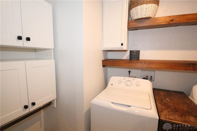 washroom featuring cabinets and washer / clothes dryer