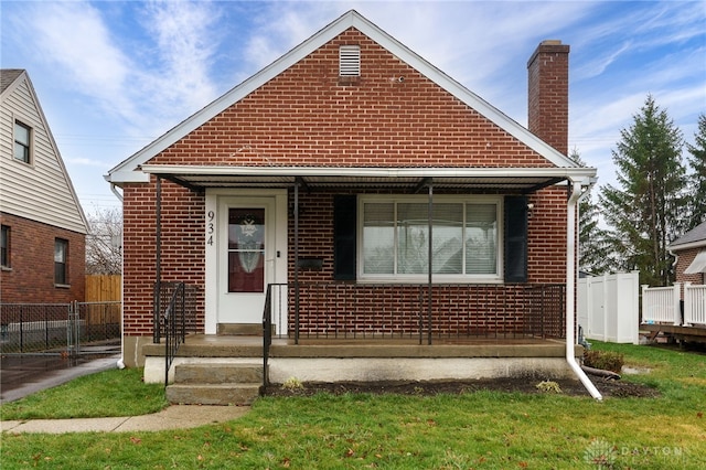 bungalow-style home featuring a front lawn