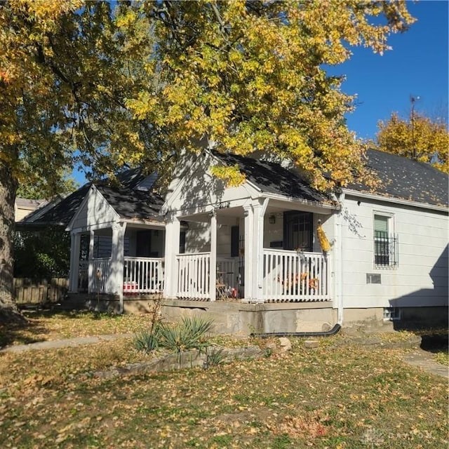 view of front of house with a front yard and a porch