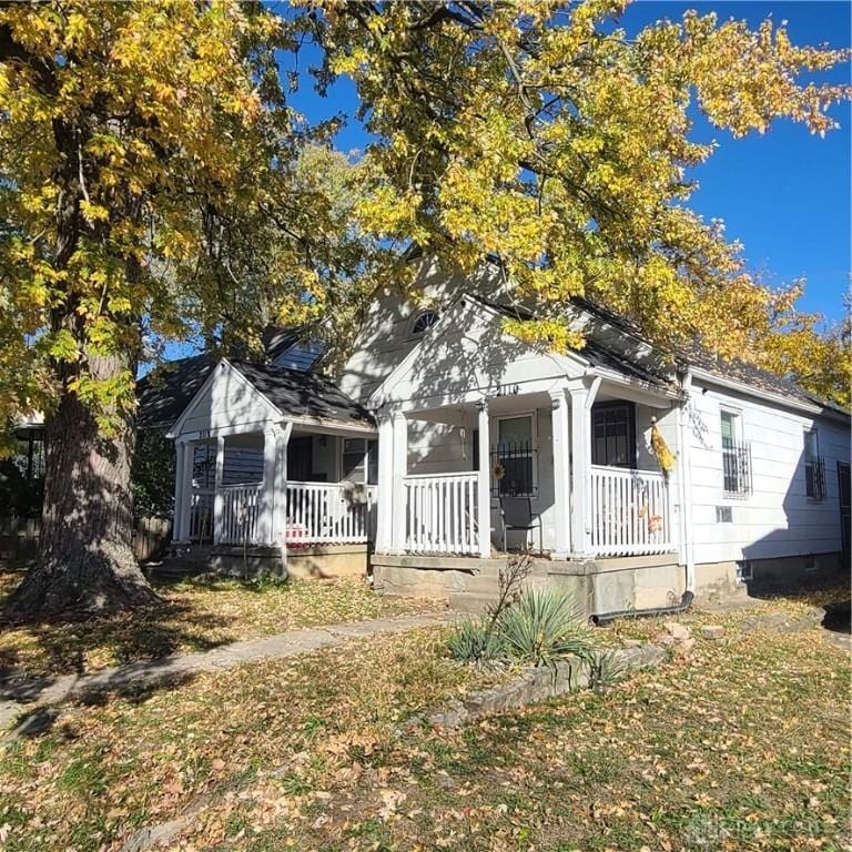 view of front of property with a front yard and a porch