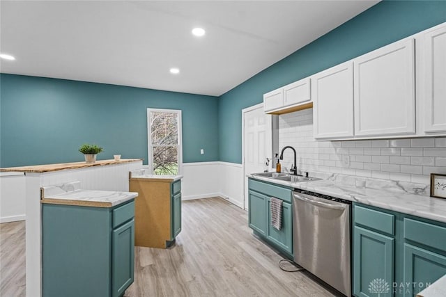 kitchen featuring white cabinetry, dishwasher, sink, decorative backsplash, and a kitchen island