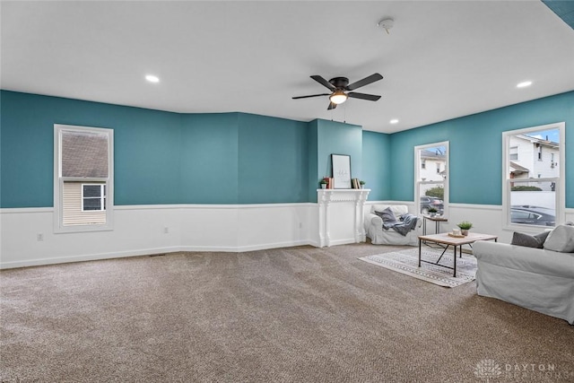 unfurnished living room featuring carpet and ceiling fan