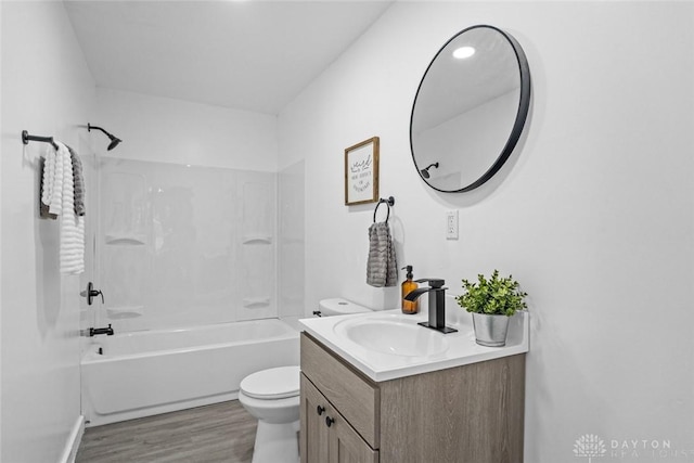 full bathroom with bathing tub / shower combination, hardwood / wood-style floors, vanity, and toilet