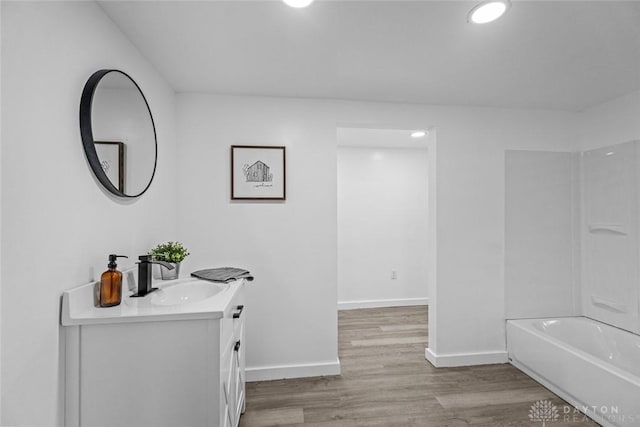 bathroom featuring shower / tub combination, vanity, and hardwood / wood-style flooring