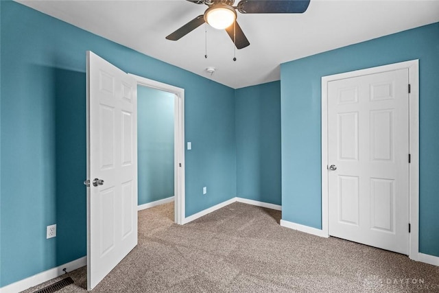 unfurnished bedroom with carpet floors and ceiling fan