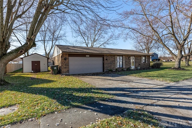 ranch-style home featuring a storage unit, a garage, and a front lawn