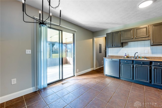 kitchen featuring decorative backsplash, stainless steel dishwasher, sink, dark tile patterned flooring, and a notable chandelier