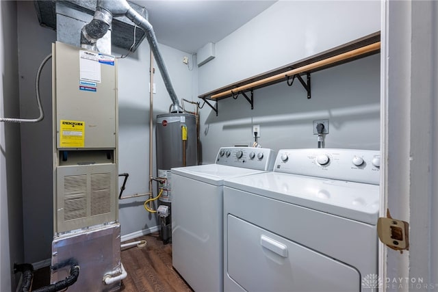 laundry area with gas water heater, washer and clothes dryer, and dark wood-type flooring