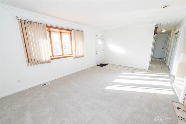 carpeted spare room with crown molding