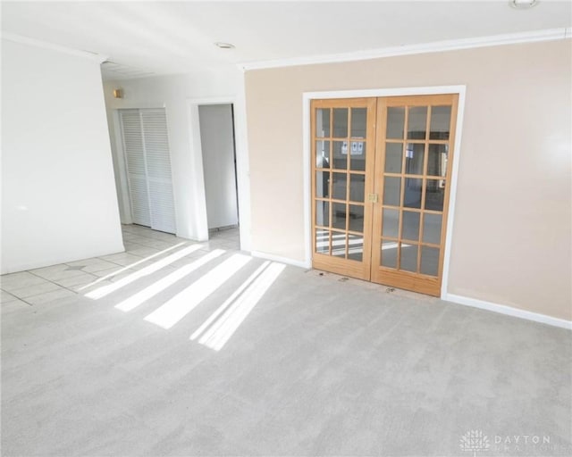 carpeted empty room with french doors and crown molding