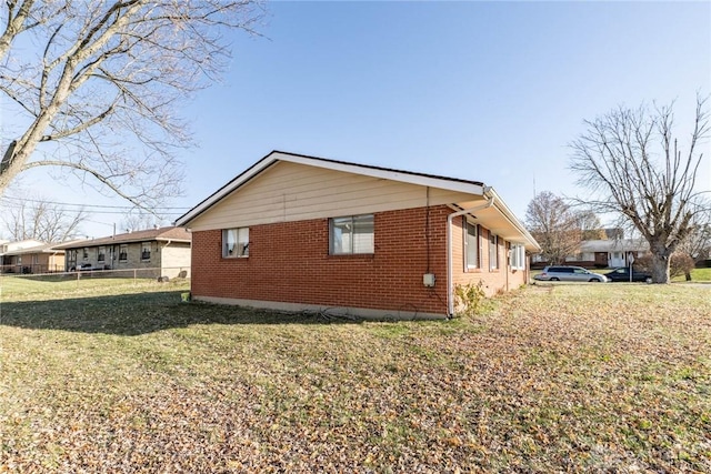 view of side of home with a lawn