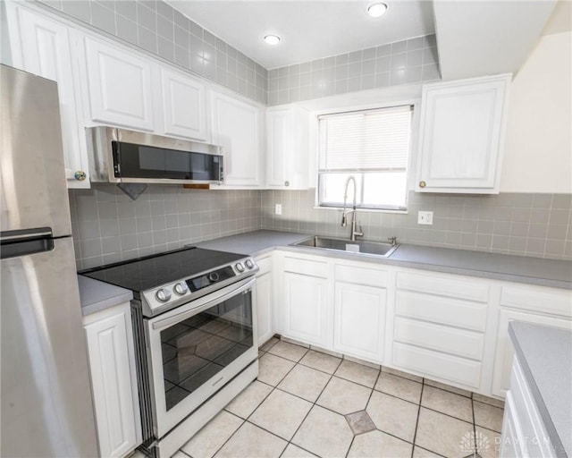 kitchen featuring sink, white cabinets, and appliances with stainless steel finishes