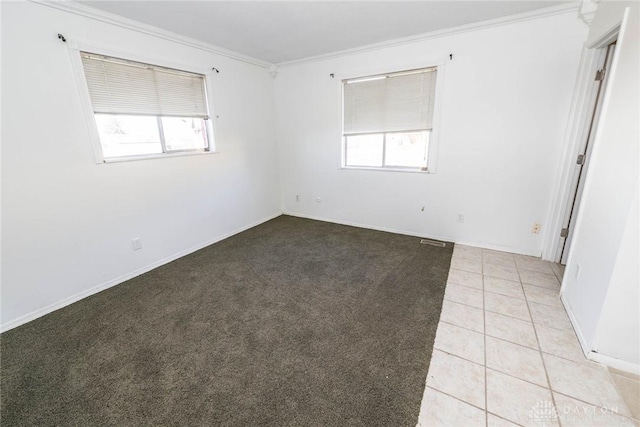 unfurnished room featuring light tile patterned floors and crown molding