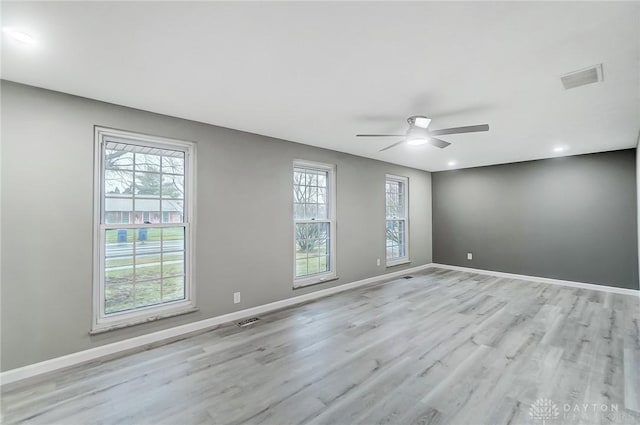 spare room with ceiling fan and light hardwood / wood-style flooring