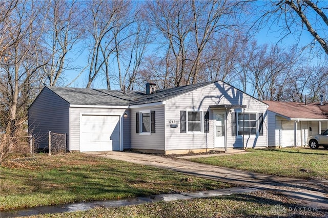 single story home featuring driveway, a front yard, and an attached garage