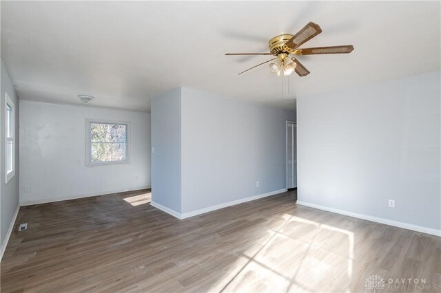 unfurnished room with hardwood / wood-style flooring and ceiling fan