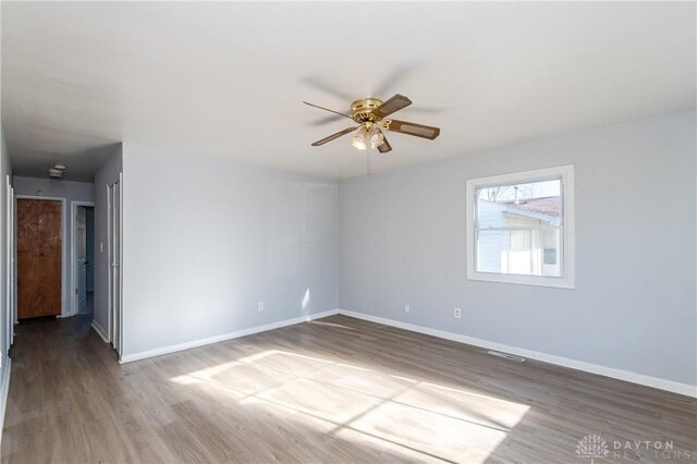 spare room with wood-type flooring and ceiling fan