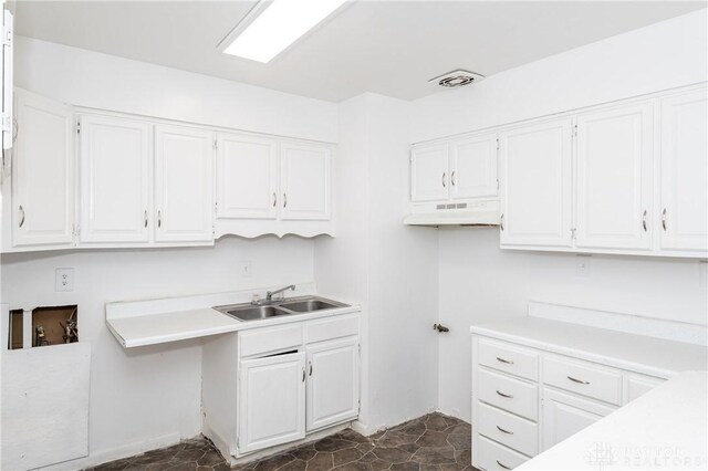 kitchen with sink and white cabinetry