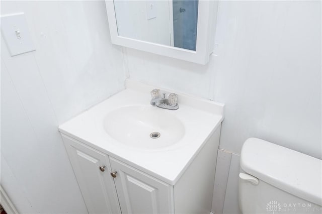 bathroom featuring toilet and vanity