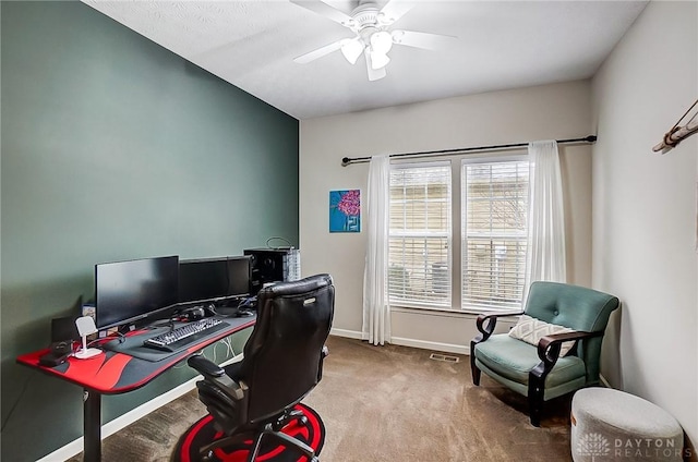 carpeted office featuring ceiling fan