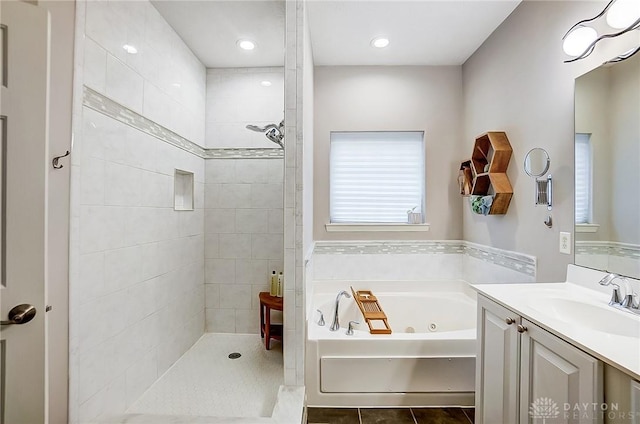 bathroom featuring tile patterned flooring, vanity, and separate shower and tub